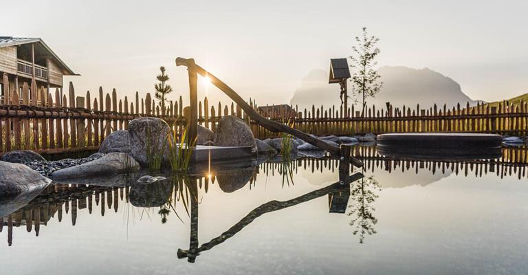 Il sole sorge sul laghetto balneabile