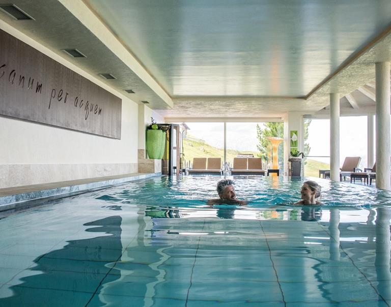 Two guests swim in the pool